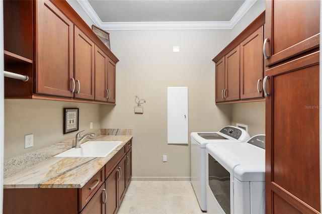 laundry area featuring cabinet space, washer and dryer, ornamental molding, and baseboards