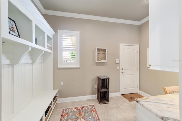 mudroom with crown molding, baseboards, and light tile patterned flooring