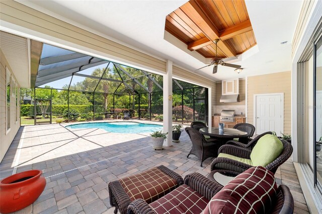 swimming pool with a patio area, a lanai, and ceiling fan