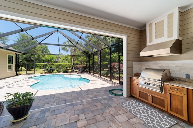 outdoor pool featuring a patio area and glass enclosure