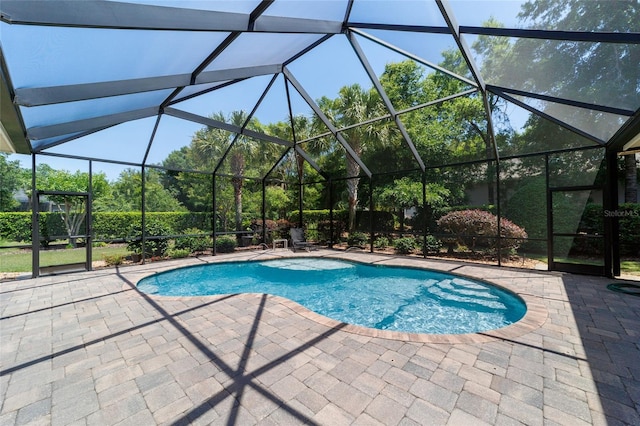 outdoor pool featuring a patio area and a lanai