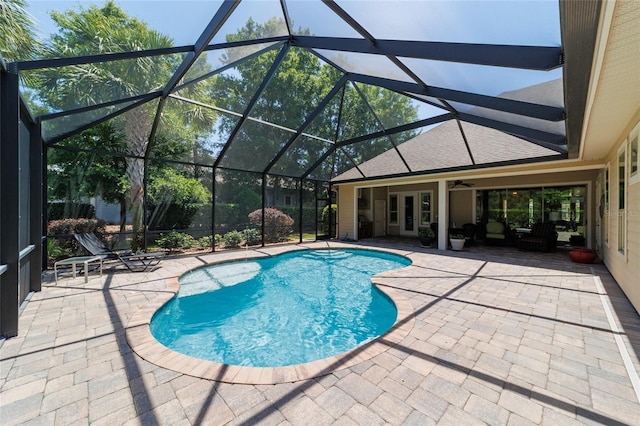 outdoor pool featuring a patio area, ceiling fan, and a lanai