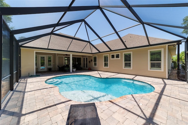 swimming pool featuring a patio, a ceiling fan, and glass enclosure