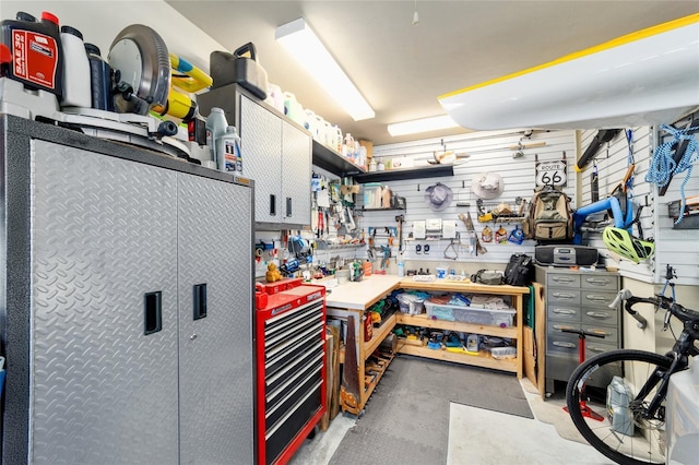 miscellaneous room with a workshop area and concrete floors