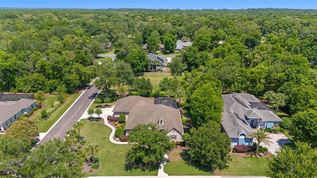 aerial perspective of suburban area featuring a heavily wooded area