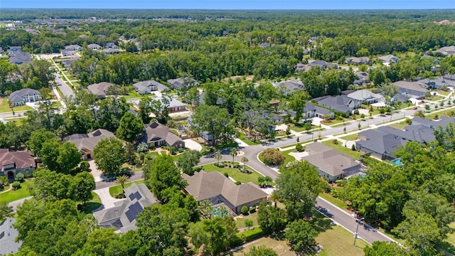 aerial view of property's location with nearby suburban area and a forest