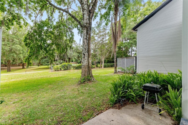 938 NW 42nd Ter, Gainesville, FL 32605 - view of grassy yard with view of wooded area