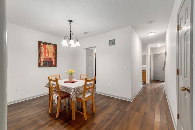 938 NW 42nd Ter, Gainesville, FL 32605 - dining space featuring a chandelier, dark wood finished floors, and baseboards