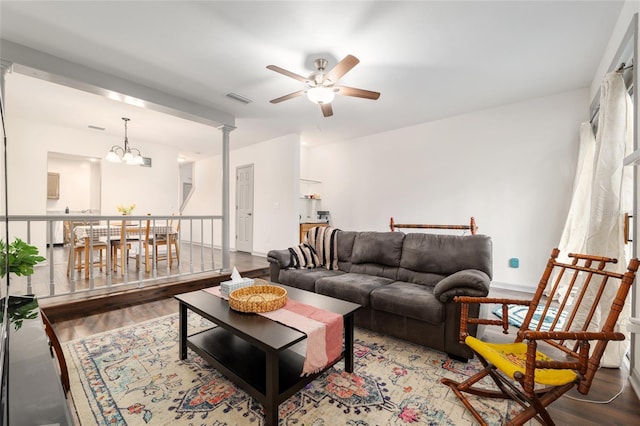 938 NW 42nd Ter, Gainesville, FL 32605 - living room featuring wood finished floors, ceiling fan, a chandelier, and baseboards