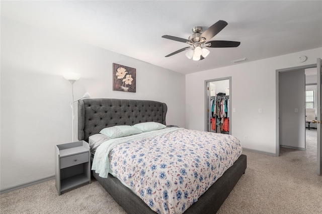 938 NW 42nd Ter, Gainesville, FL 32605 - bedroom with light colored carpet, a spacious closet, baseboards, a ceiling fan, and a closet