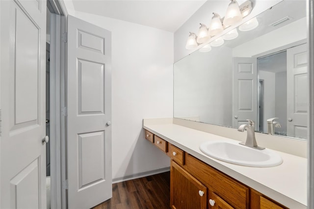 938 NW 42nd Ter, Gainesville, FL 32605 - bathroom with wood finished floors, vanity, and baseboards