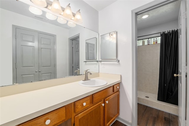 938 NW 42nd Ter, Gainesville, FL 32605 - full bath featuring a shower stall, wood finished floors, and vanity