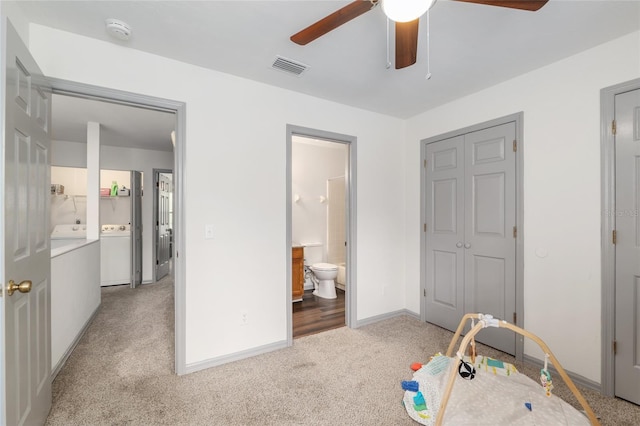938 NW 42nd Ter, Gainesville, FL 32605 - bedroom featuring light carpet, baseboards, connected bathroom, and a ceiling fan