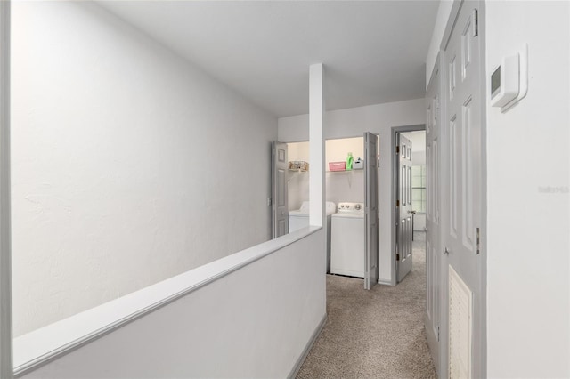 938 NW 42nd Ter, Gainesville, FL 32605 - corridor with light colored carpet and washing machine and clothes dryer