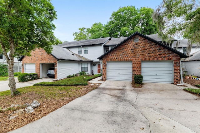 938 NW 42nd Ter, Gainesville, FL 32605 - traditional-style house with brick siding, concrete driveway, and a garage