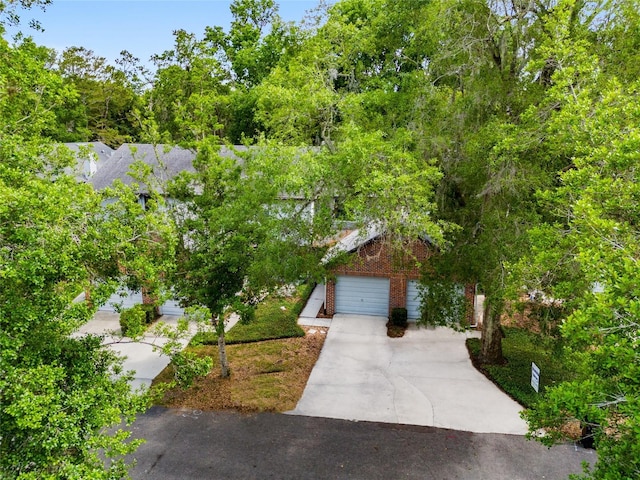 938 NW 42nd Ter, Gainesville, FL 32605 - obstructed view of property featuring driveway and brick siding