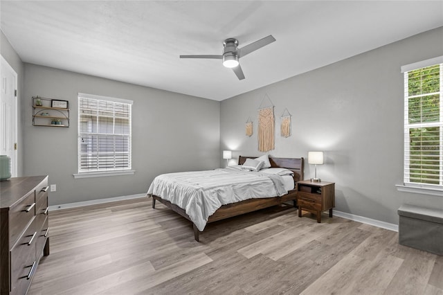 bedroom featuring baseboards, a ceiling fan, and light wood-style floors