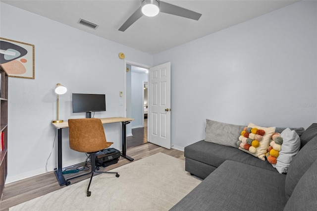 office area featuring visible vents, wood finished floors, baseboards, and ceiling fan