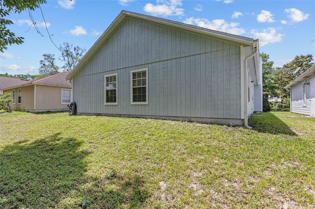 rear view of property featuring a lawn