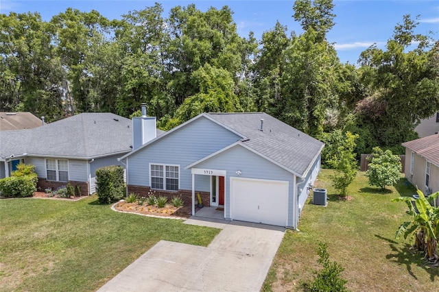 ranch-style home with a chimney, driveway, an attached garage, central air condition unit, and a front lawn