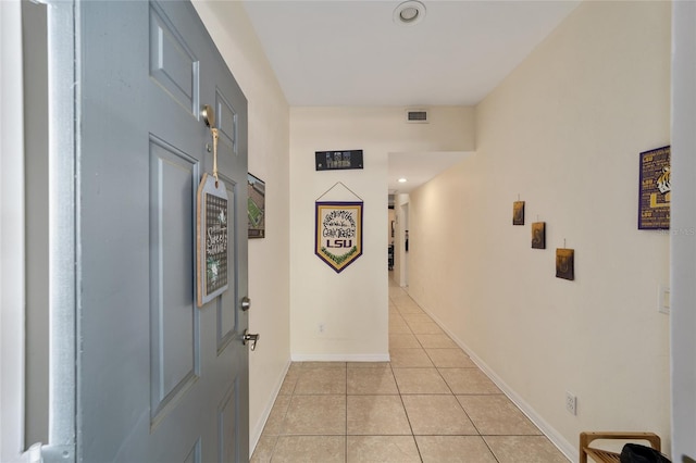 corridor with light tile patterned floors, recessed lighting, baseboards, and visible vents