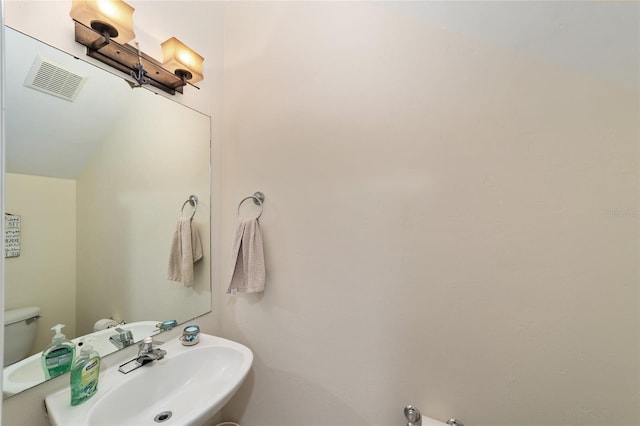bathroom with visible vents and a sink