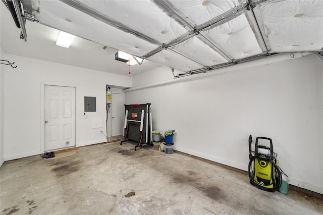 garage featuring electric panel, baseboards, and a garage door opener
