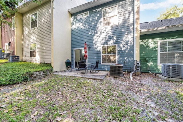 rear view of property featuring cooling unit and a patio
