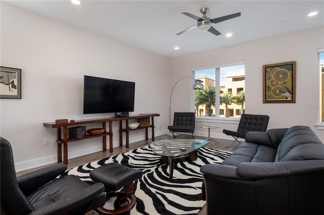 living room with a ceiling fan, baseboards, recessed lighting, and wood finished floors