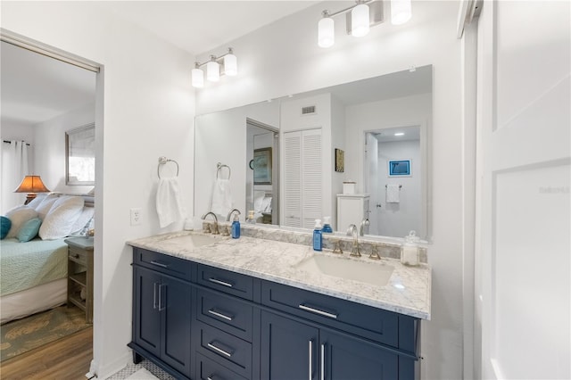 205 Pacifica Vista Way Unit 205, Saint Augustine, FL 32080 - ensuite bathroom featuring ensuite bath, double vanity, a sink, and wood finished floors