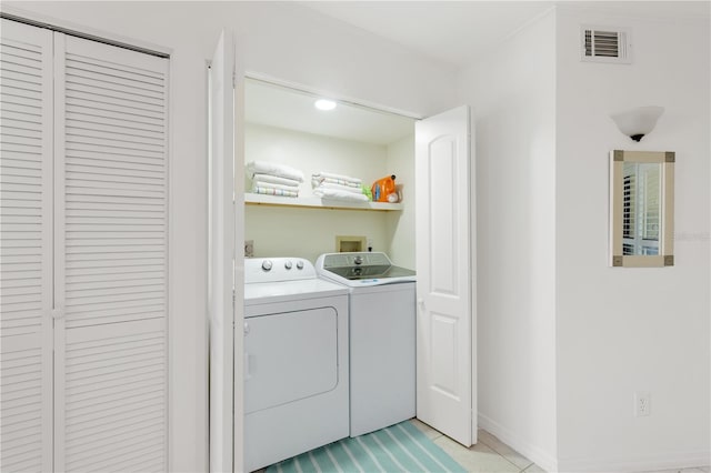 205 Pacifica Vista Way Unit 205, Saint Augustine, FL 32080 - laundry room with washing machine and dryer, light tile patterned floors, laundry area, visible vents, and baseboards