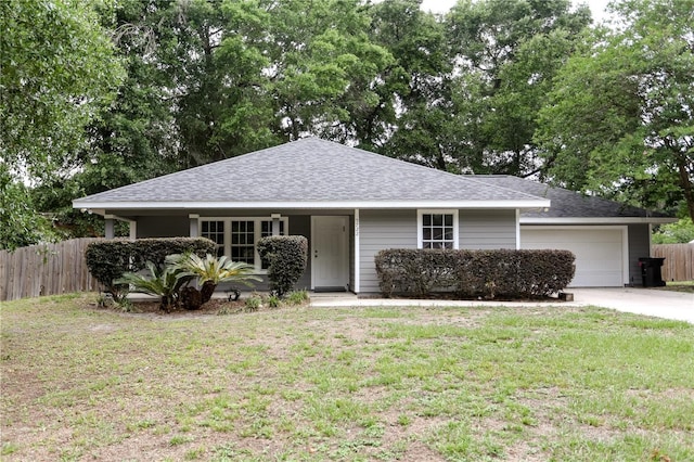 ranch-style house with a garage, driveway, and roof with shingles