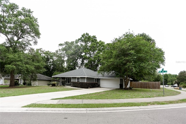 single story home featuring concrete driveway and a garage
