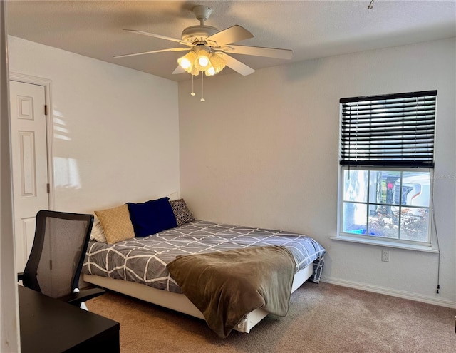 carpeted bedroom with baseboards and ceiling fan