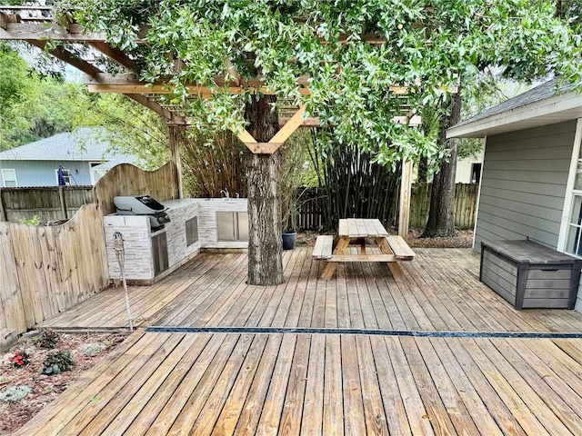 deck with a fenced backyard, a pergola, area for grilling, and outdoor dining space