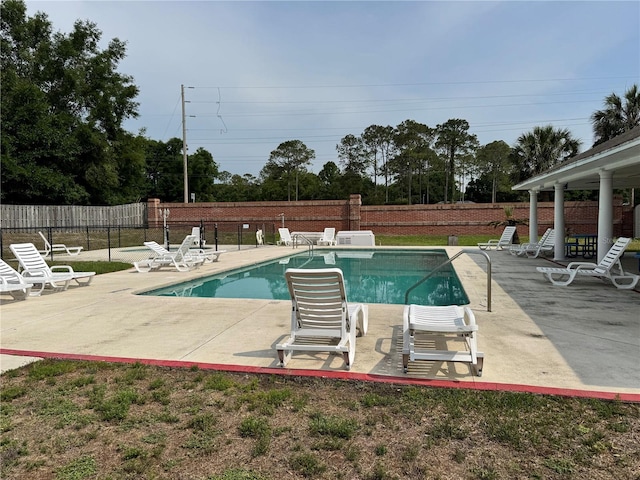 community pool featuring a patio and fence