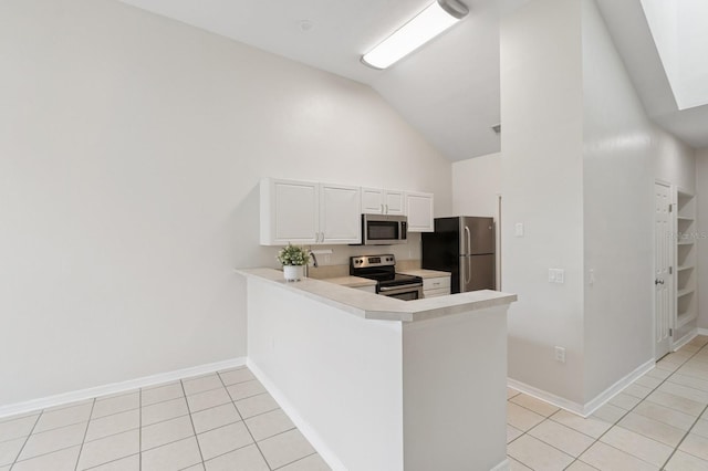 kitchen featuring appliances with stainless steel finishes, light tile patterned floors, light countertops, high vaulted ceiling, and white cabinets