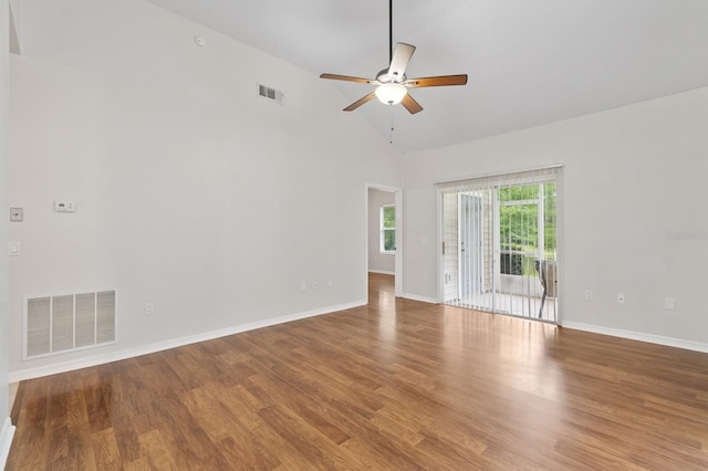 spare room featuring ceiling fan, baseboards, wood finished floors, and high vaulted ceiling