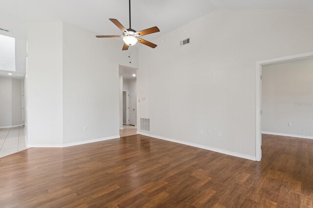 unfurnished room featuring high vaulted ceiling, ceiling fan, baseboards, and wood finished floors