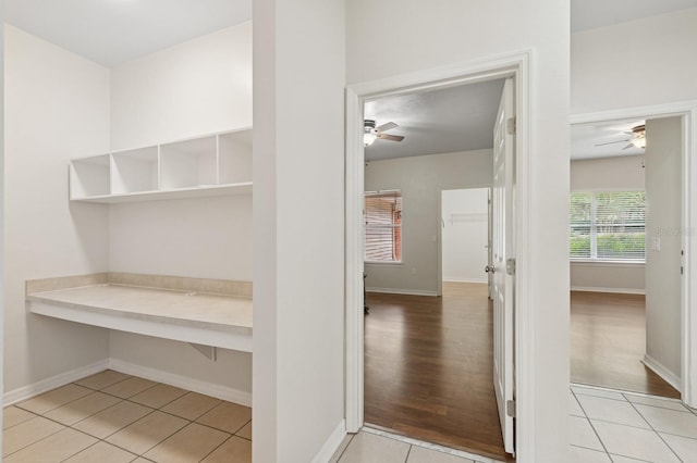 mudroom featuring ceiling fan, light tile patterned flooring, and baseboards