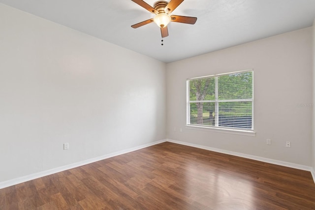 empty room with baseboards, wood finished floors, and ceiling fan
