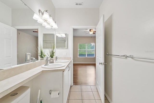 full bathroom featuring tile patterned flooring, ceiling fan, double vanity, and toilet