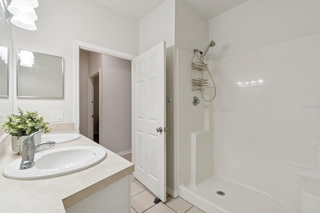 full bathroom featuring tile patterned flooring, a walk in shower, and double vanity