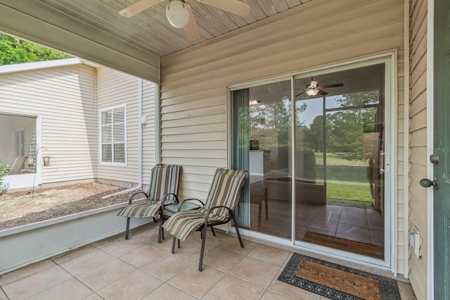 view of exterior entry with a ceiling fan and a patio