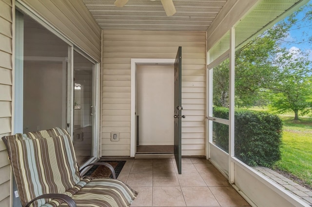 unfurnished sunroom with ceiling fan and healthy amount of natural light