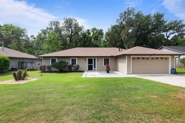 9505 NW 4th Pl, Gainesville, FL 32607 - single story home featuring a front yard, an attached garage, driveway, and fence