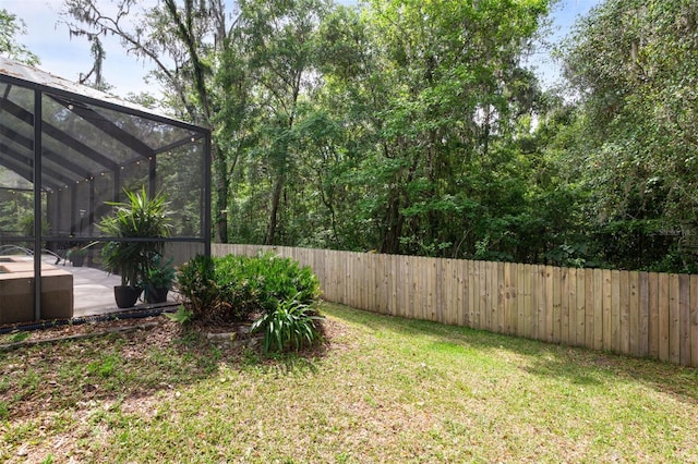 9505 NW 4th Pl, Gainesville, FL 32607 - view of yard with a fenced backyard and a lanai
