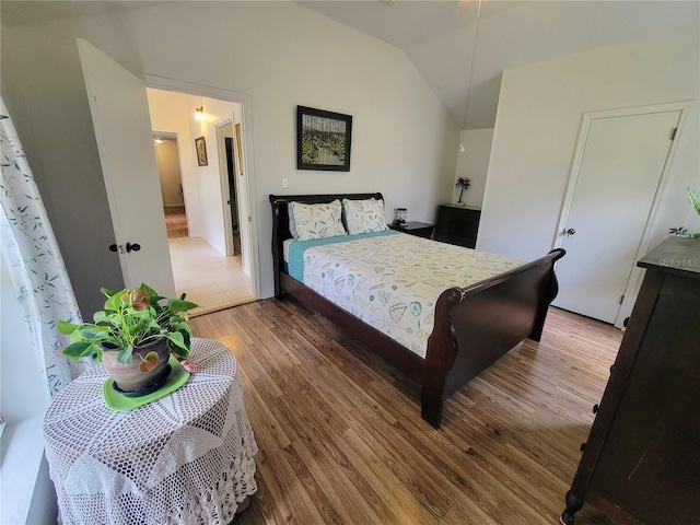 9150 SW 151st Ln, Archer, FL 32618 - bedroom with lofted ceiling and wood finished floors