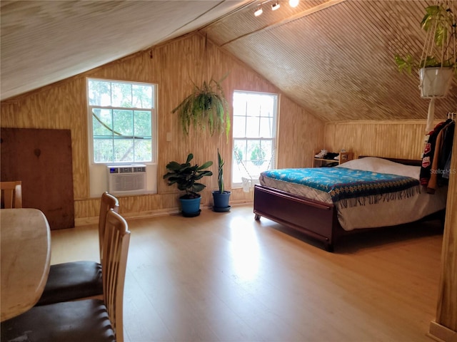 9150 SW 151st Ln, Archer, FL 32618 - bedroom featuring lofted ceiling, wood finished floors, cooling unit, and wood walls
