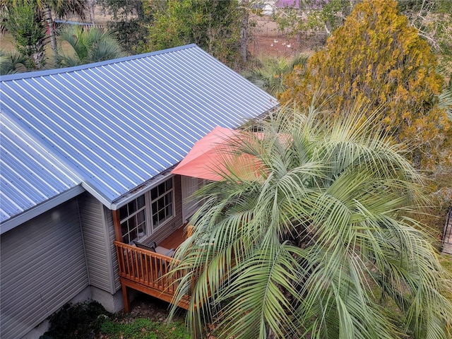 9150 SW 151st Ln, Archer, FL 32618 - view of property exterior with metal roof and a deck
